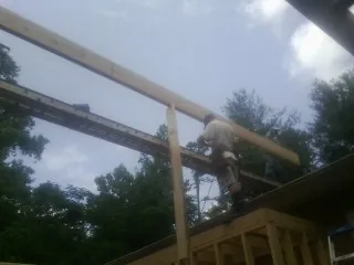 Carpenter setting a ridge beam over a new addition frame — Ice Dam Removal by Roofing Brothers in Willowbrook