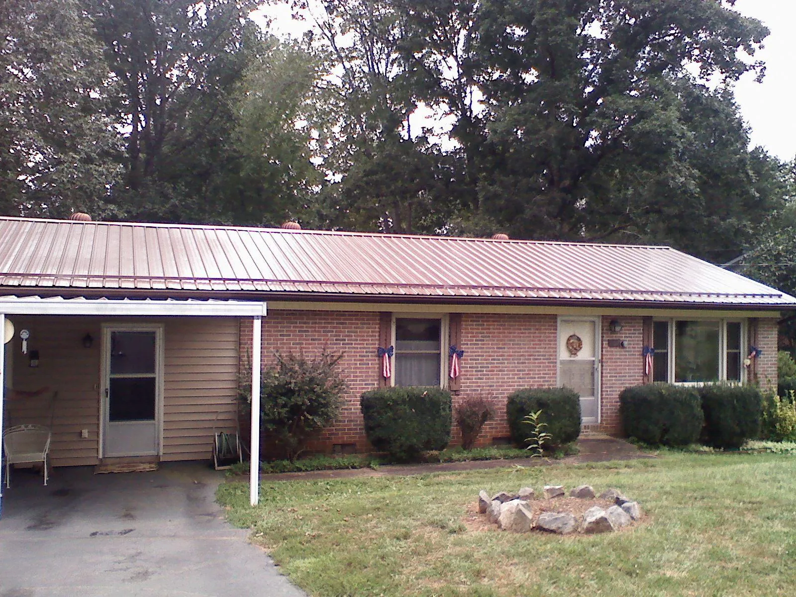 Bronze metal roof and carport on a brick ranch home — Roof Repair work by our crew in Willowbrook